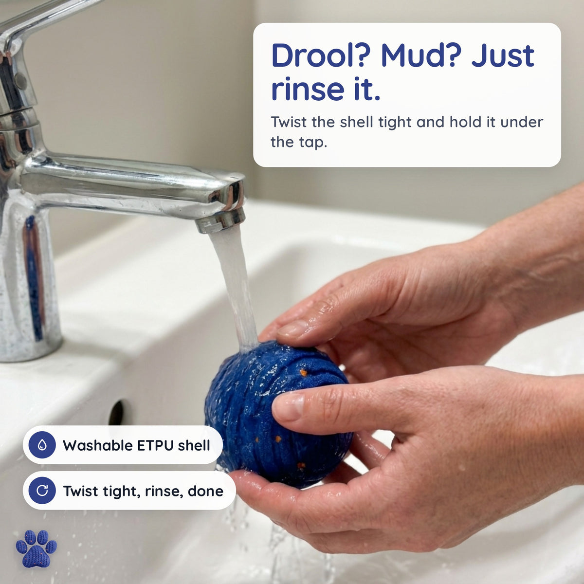Rinsing the closed Zoomipaw ball under the tap